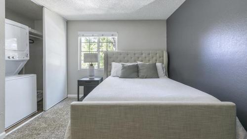 a bedroom with a large bed with a window at Landing Modern Apartment with Amazing Amenities (ID9974X77) in Sparks