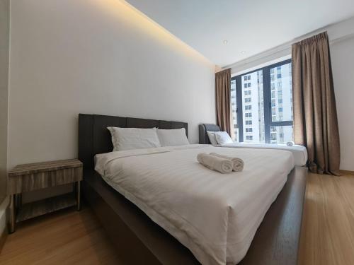 a bedroom with a large bed with a large window at Harmony Haven with Bathtub - Jazz Suites by Ocean Luxe in Tanjong Tokong