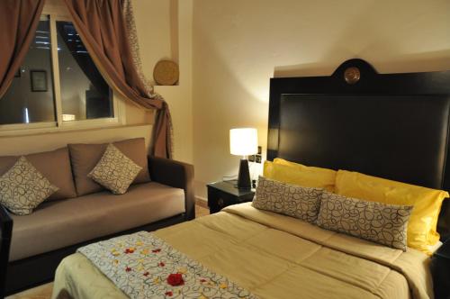 a hotel room with a bed and a couch at Riad Al Madina in Essaouira