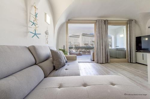 a living room with a couch and a television at Gardenia Luxury in Palau