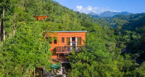 a wooden house in the middle of a mountain at Secret Bay in Portsmouth