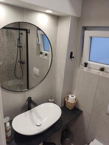 a bathroom with a sink and a mirror at LUX ARENA RESIDENCE EMA in Pula
