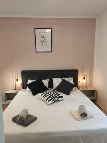 a bedroom with a bed with two towels on it at LUX ARENA RESIDENCE EMA in Pula