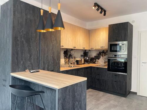 a kitchen with wooden cabinets and a counter top at 3 BR Apt, Spacious, Near South Park in Sofia