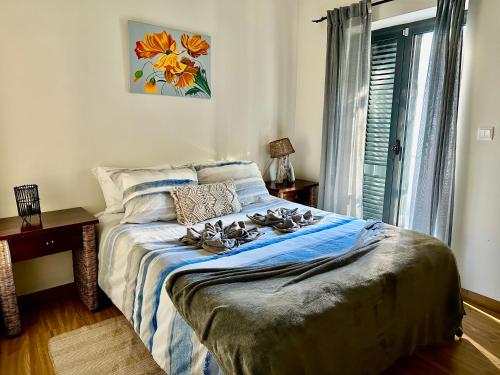 a bedroom with a bed with birds on it at Love, made in xisto in Piódão