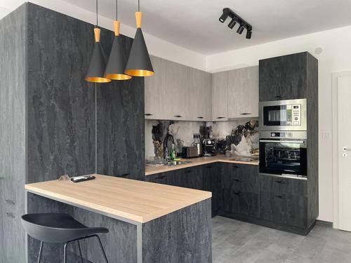 a kitchen with a wooden counter and a stove top oven at 3 BR Apt, Spacious, Near South Park in Sofia