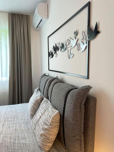 a bedroom with a couch and a picture on the wall at 3 BR Apt, Spacious, Near South Park in Sofia