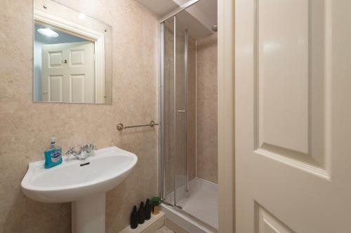 a bathroom with a sink and a shower at Parade Watch in Bath