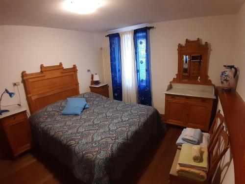 a bedroom with a bed and a dresser and a sink at Issime - da Carla (CIR n. 0001) in Issime