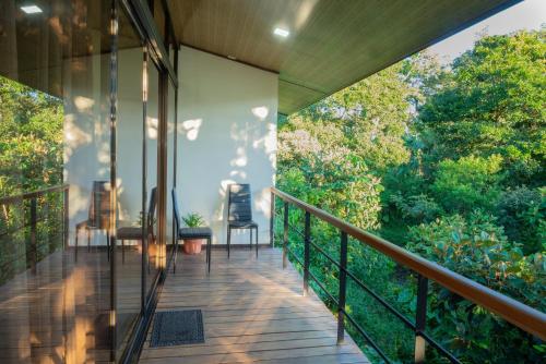 a balcony of a house with a view of trees at Modern Loft inside a beautiful farm in General Viejo