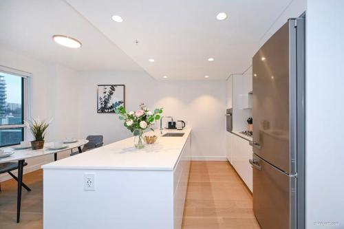 eine Küche mit einer weißen Theke und einem Kühlschrank in der Unterkunft new apartment 3 bedrooms in Richmond