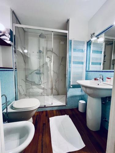 a bathroom with a shower and a toilet and a sink at About Italy Holiday Rooms and Apartments in Portovenere