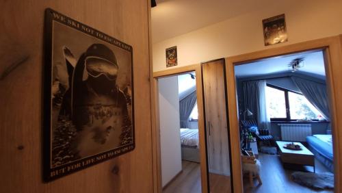 a room with a picture on the wall and a bedroom at PinePino Borovets, aparthotel Borovets Gardens A60 in Borovets