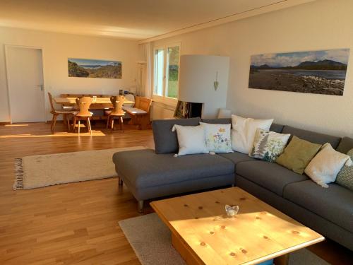 a living room with a couch and a table at Rigiana auf der Königin der Berge in Rigi Kaltbad