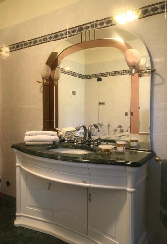 a bathroom with a sink and a large mirror at VILLA COLLE in Ranzanico