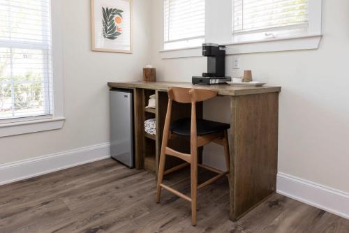 een kleine keuken met een houten bureau met een kruk bij The Waverly 100 Inn at Old Beach in Virginia Beach