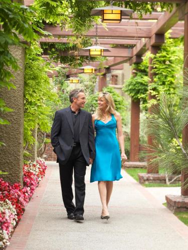 a man and a woman walking down a walkway at The Lodge at Torrey Pines in San Diego