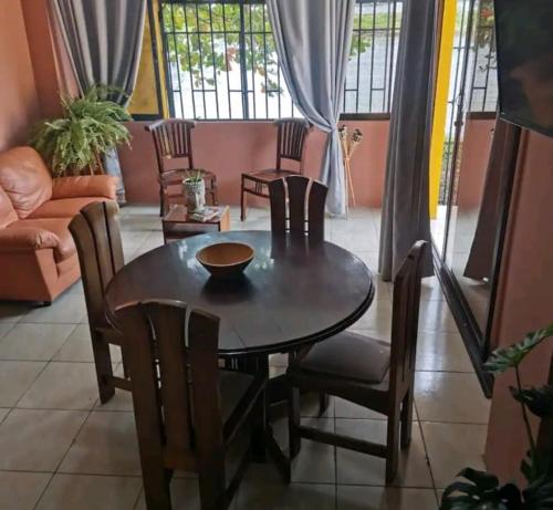 a dining room with a table and chairs at Hostal Apartamento con salida al mar in Puerto Limón