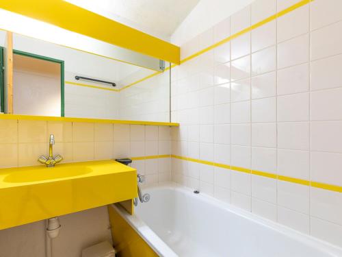 a bathroom with a yellow sink and a tub at Duplex 7 pers avec WIFI, balcon à Avoriaz - FR-1-314-246 in Morzine