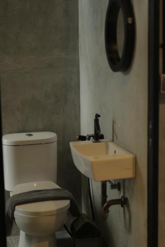 a bathroom with a toilet and a sink at nava one in Candi