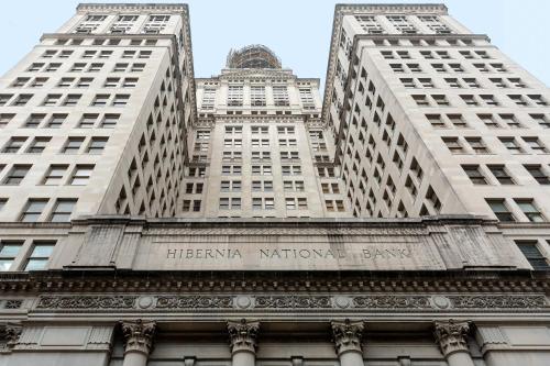 two tall buildings with the name of the harlem national bank at Roami at Hibernia Tower in New Orleans