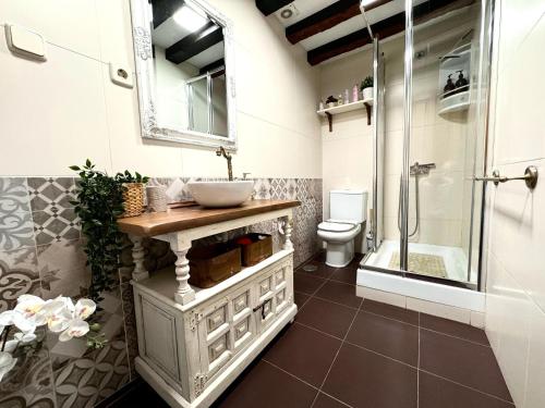 a bathroom with a sink and a shower and a toilet at Suite Imperial I * Historic Center * Early Check-in in Toledo