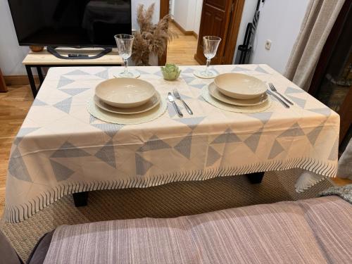 a table with plates and silverware on top of it at Suite Imperial I * Historic Center * Early Check-in in Toledo