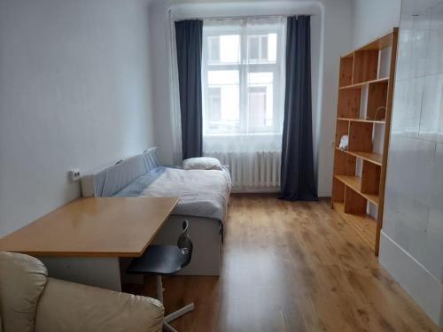 a living room with a desk and a couch at Comfy apartment with 2 bedrooms in Rīga