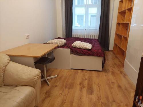 a room with a desk and a bed and a table at Comfy apartment with 2 bedrooms in Rīga