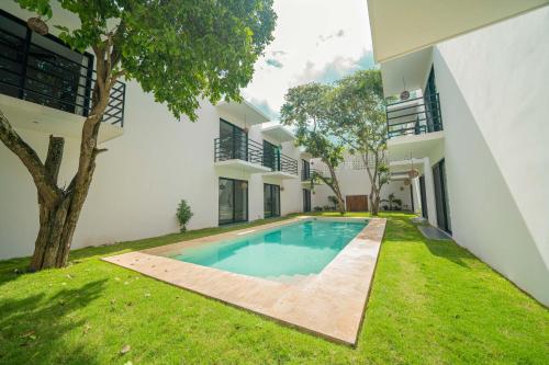 an external view of a house with a swimming pool at Luna Azul Bacalar in Bacalar