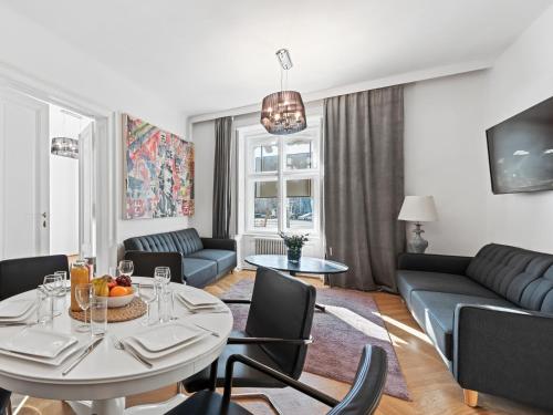 a living room with a table and a couch at SKY9 Apartments City Center in Vienna