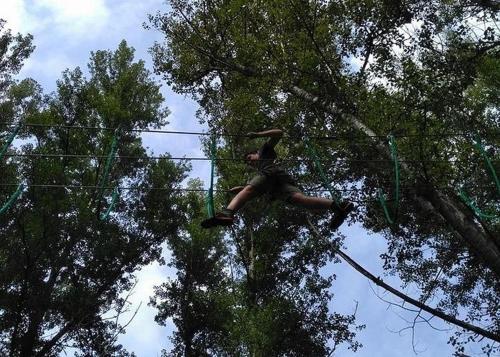 a person on a zip line in the trees at Gîte Cosy - 72m2 - Hyper Centre - Tout équipé in Langeac