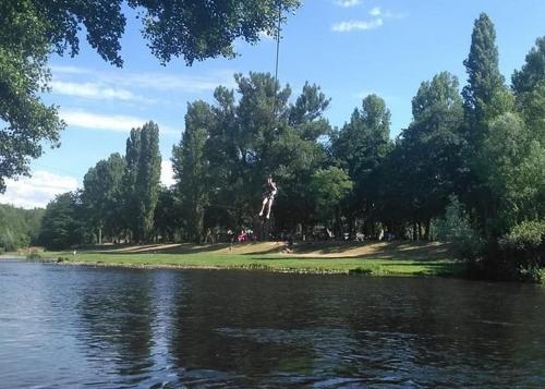 a person jumping into a body of water at Gîte Cosy - 72m2 - Hyper Centre - Tout équipé in Langeac