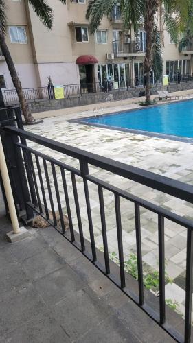 a black fence next to a swimming pool at R2R ROOM in Bulanbulan