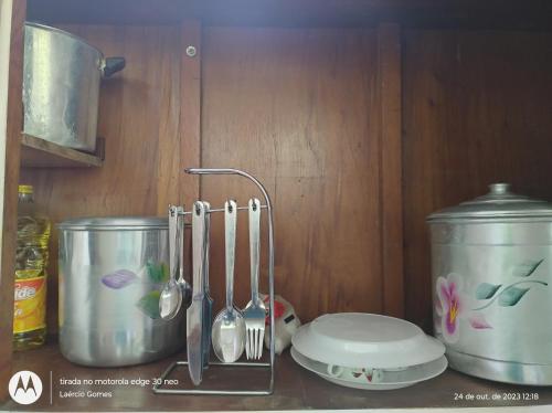 a kitchen counter with utensils on a counter top at ESPAÇO ShEHERAZADE PISCINA & LAZER in Juquitiba