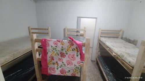 two beds in a room with a pillow on it at ESPAÇO ShEHERAZADE PISCINA & LAZER in Juquitiba