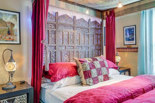 a bedroom with a bed with red curtains at Retro El Sobrante Apartment Near San Francisco! in El Sobrante