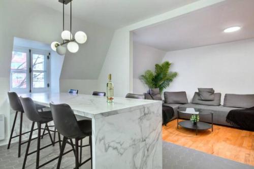 a kitchen and living room with a marble counter top at Golden Cross // Typical old Quebec appartement in Quebec City