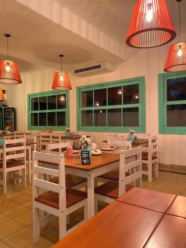 a dining room with a table and chairs and lights at Hotel Vista La Floresta in La Floresta