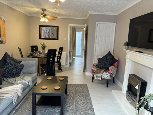 a living room with a couch and a fireplace at Cosy Corner - 2 bed house with parking! in Southampton