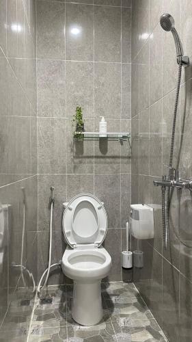 a bathroom with a toilet and a shower at i Two Panorama Villas in Batu