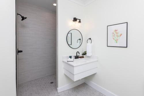 a bathroom with a sink and a mirror at Newcastle 106 Inn at Old Beach in Virginia Beach