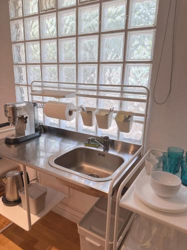 a kitchen with a sink and a window at Stylish & Cozy Studio in Igoumenitsa