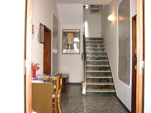 a hallway with a staircase with shoes at B&B Itala in Recanati