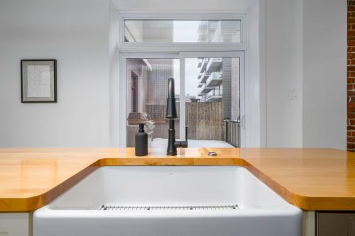 a kitchen with a sink and a window at -NEW- The Rock and Red Luxury Condo in Quebec City