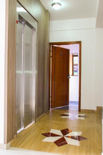 a hallway with a door and a tile floor at Müller Hotel in Bella Vista