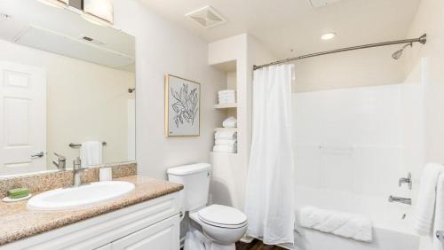 Baño blanco con aseo y lavamanos en Landing Modern Apartment with Amazing Amenities (ID7594X27) en San Diego