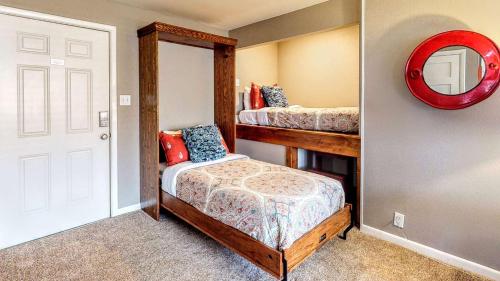 a small bedroom with two beds and a mirror at Downtown Cozy Home Base - Purple Sage 7 in Moab