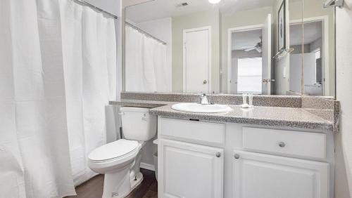 a white bathroom with a toilet and a sink at Landing Modern Apartment with Amazing Amenities (ID3802X2) in Atlanta