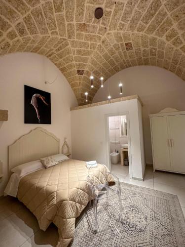 a bedroom with a bed with a stone ceiling at Palazzo Alma luxury rooms in Casarano